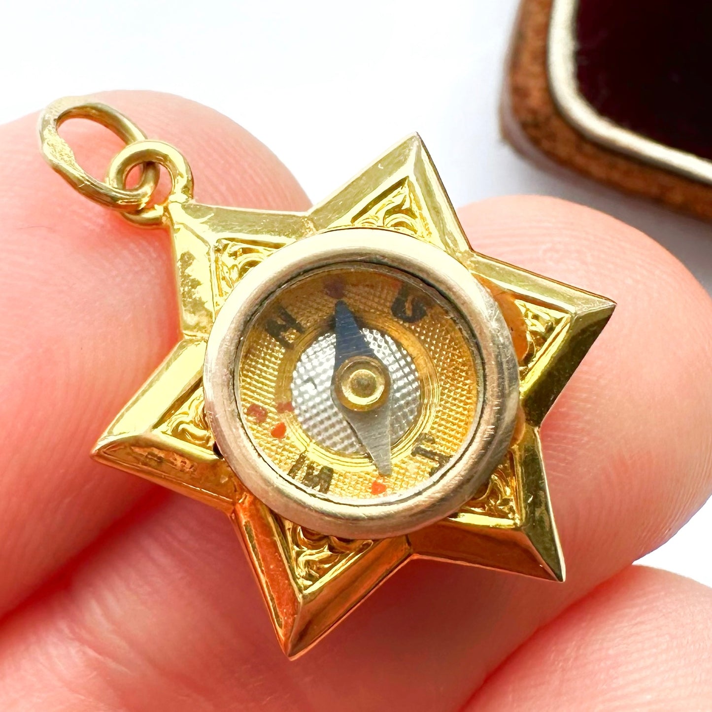 Antique 18ct gold star compass charm